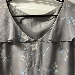 Handmade petal sleeves and high- low hem line; gray background;zips under rt arm